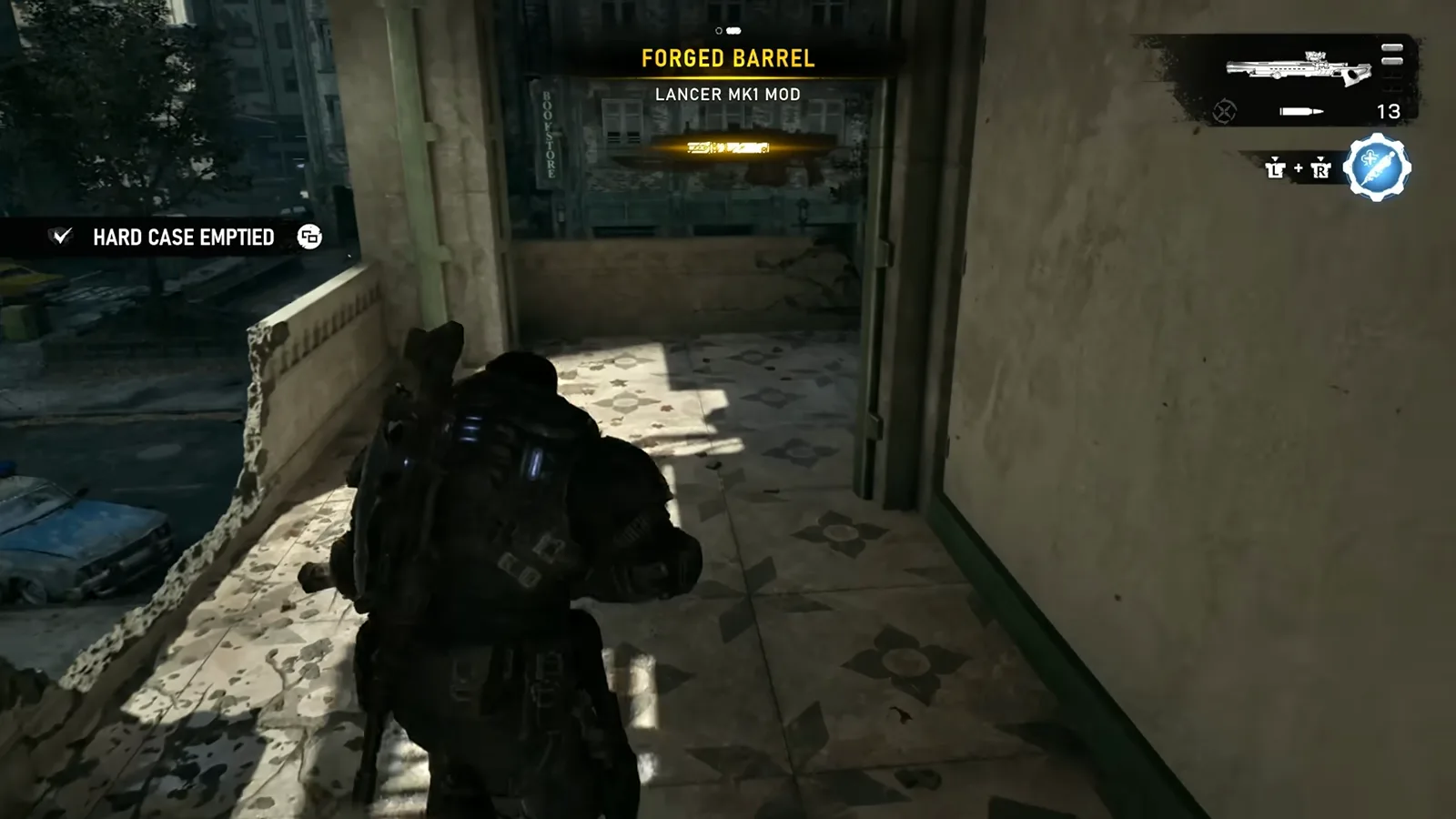A Forged Barrel Lancer Mk1 mod glowing on the ground next to a Hard Case the player just emptied in a snowy courtyard